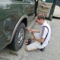 Driver Checking the Car Air Pressure