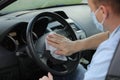 The driver cleans the steering wheel of his car with an antibacterial cloth. Antiseptic, Hygiene and Healthcare concept. selective Royalty Free Stock Photo