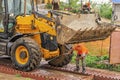 Driver at the construction site washes the excavator on the overpass