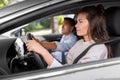 car driving school instructor teaching woman