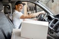 Driver delivering goods by vehicle Royalty Free Stock Photo