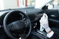 Driver Disinfecting Steering Wheel In Car