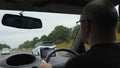 Driver driving car on highway in England using satnav