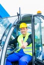 Driver driving construction excavator