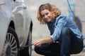 driver filling air into car tire Royalty Free Stock Photo