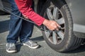 Driver filling air in a tire of a car Royalty Free Stock Photo