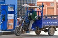 Driver in filling station, Morocco