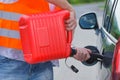 Driver fills the fuel in an empty car tank from canister Royalty Free Stock Photo