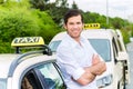 Driver in front of taxi waiting for clients Royalty Free Stock Photo