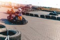 A driver in gear and helmet drives a racing car. In action. Go karts racing, sreet karting, rent. extreme sport. fun entertainment