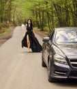 Driver girl. Beauty and fashion. Woman in black dress. Elegant lady escort service worker. Sexy girl elegant dress at Royalty Free Stock Photo