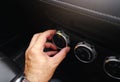 The driver hand adjusts the temperature of the car air conditioner, Hand turn the switch to select the temperature level.