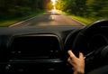 Driver hand holding steering wheel for control car. Inside view of car. Dashboard and windshield. Driving car on asphalt road Royalty Free Stock Photo