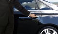 Driver hand opening car door Royalty Free Stock Photo