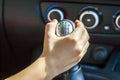 Driver hand shifting gear shift knob manually, selective focus