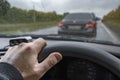 The driver hand on the steering wheel of a car in a traffic jam due to road repairs Royalty Free Stock Photo