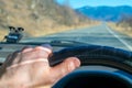 Driver hand on the steering wheel inside the car Royalty Free Stock Photo