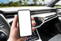 Driver hand using smartphone in car. Smartphone in a car use for Navigate or GPS. Mobile phone with  white screen. Blank Royalty Free Stock Photo
