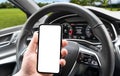 Driver hand using smartphone in car. Smartphone in a car use for Navigate or GPS. Mobile phone with  white screen. Blank Royalty Free Stock Photo