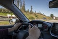 Driver hands on the steering wheel. Man driving a car on the highway, with motion blurred by speed. Royalty Free Stock Photo