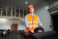 Driver in hardhat working on forklift at warehouse Royalty Free Stock Photo