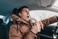 driver has a sharp drop in blood sugar and he urgently eats a banana while driving through the streets in winter. The concept