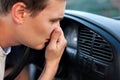 The driver held his nose from the bad smell , air conditioner heating, the concept of faulty air conditioners, bad smell and car,