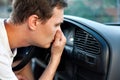 The driver held his nose from the bad smell , air conditioner heating, the concept of faulty air conditioners, bad smell and car,