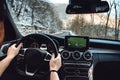 Male driver holding hands on steering wheel and driving on mountain road. Man using navigation system Royalty Free Stock Photo