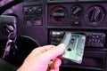 The driver inserts a cassette into a cassette recorder in an old car. Royalty Free Stock Photo