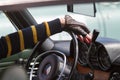 driver keeps hands on steering wheel of his vintage car Royalty Free Stock Photo