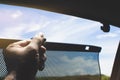 Driver is lifting car side window curtains sunshades