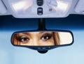 Driver looks to rear view mirror Royalty Free Stock Photo