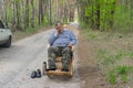 Driver man resting outside of his car sleeping in a wicker rocking-chair