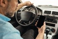 Driver man using smartphone with empty screen driving car Royalty Free Stock Photo