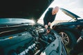 Driver odf car engineer fixing car battery outdoors. Closeup view Royalty Free Stock Photo