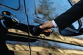 Driver opening door of luxury car, closeup. Chauffeur service Royalty Free Stock Photo