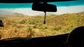 Driver Point of view. Driver driving off road drive car on the mountain dry forest country road. inside car windshield view point Royalty Free Stock Photo