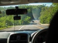 Driver Point of view. Driver driving off road drive car on the mountain green forest country road. inside car windshield view Royalty Free Stock Photo