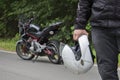 Driver riding motorcycle on an asphalt road through forest. Royalty Free Stock Photo