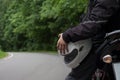 Driver riding motorcycle on an asphalt road through forest. Royalty Free Stock Photo