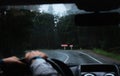 Driver`s hand on a steering wheel inside a car on a road Royalty Free Stock Photo