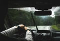 Driver`s hand on a steering wheel inside a car on a road Royalty Free Stock Photo