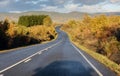 Driver`s view of winding highway and fall foliage. Royalty Free Stock Photo