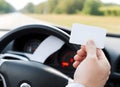 on driver seat, showing business card, identification card or drivers license