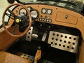 Driver seat, steering wheel and vintage dashboard of Vanderhall Venice Speedster, three-wheeled hand made autocycle