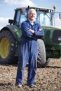 Driver Standing In Front Of Tractor