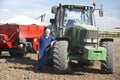 Driver Standing In Front Of Tractor