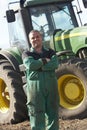 Driver Standing In Front Of Tractor