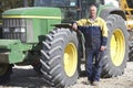 Driver Standing In Front Of Tractor